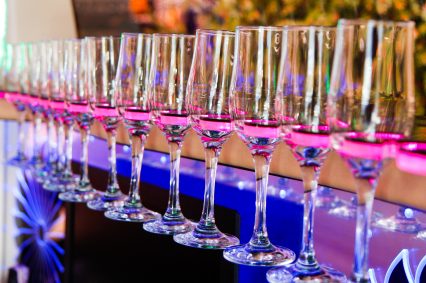 Glasses for champagne and wines in a special holder with lighting inside the limousine close-up